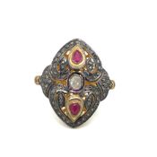 A POLKI DIAMOND AND RUBY PIERCED WORK LARGE PANEL RING MOUNTED IN SILVER GILT. FINGER SIZE N. WEIGHT