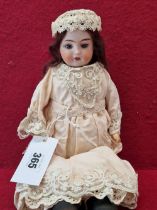 A STROBEL & WILKEN DARLING BISQUE HEADED DOLL WITH FIXED EYES AND OPEN MOUTH. H 33cms