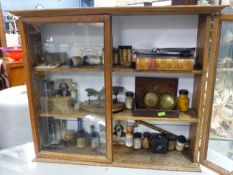 A VINTAGE GLAZED OAK CHEMISTS WALL CABINET AND CONTENTS.