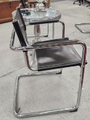 A SET OF FOUR TUBULAR CHROME AND BLACK LEATHER ELBOW CHAIRS