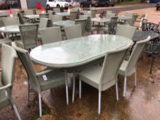 A LARGE OVAL LLOYD LOOM PATIO TABLE AND 6 MATCHING CHAIRS