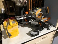 A MITRE SAW WITH FOLDING ROLLER TABLE AND TRANSFORMER.