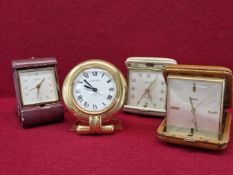 A VINTAGE CARTIER DESK CLOCK, A LOOPING SWISS TRAVEL CLOCK IN FOLDING RED LEATHER BOUND CASE, A
