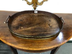 A 19TH CENTURY BRASS BOUND MAHOGANY TWO HANDLED OVAL TRAY. W 51cms.