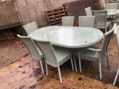 A LARGE OVAL LLOYD LOOM PATIO TABLE AND 6 MATCHING CHAIRS