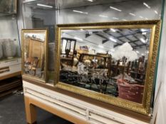 TWO GILT FRAMED BEVELLED GLASS MIRROR, THE LARGER REVERSE ENGRAVED WITH A PONY AND TRAP