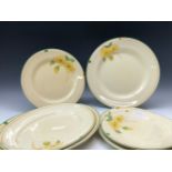 THREE CLARICE CLIFF HONEYGLAZE PLATTERS EN SUITE WITH FOUR PLATES, EACH WITH TWO YELLOW FLOWERS