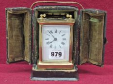 A LEATHER CASED CARRIAGE TIMEPIECE WITH A WHITE ENAMEL DIAL, THE CASE. H 15.5cms.