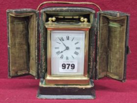 A LEATHER CASED CARRIAGE TIMEPIECE WITH A WHITE ENAMEL DIAL, THE CASE. H 15.5cms.