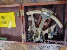 A MAHOGANY CASED H HUGHES SEXTANT NUMBERED 20000 CHECKED AS ACCURATE BY COOKE AND SON IN 1965