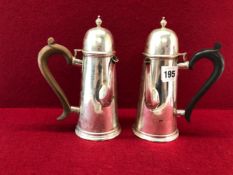 TWO SILVER CHOCOLATE POTS BY WAKELY AND WHEELER, LONDON 1909 AND 1911, WITH BROWN AND BLACK