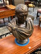 A BRONZED PLASTER BUST OF JULIUS CAESAR, HIS TOGA SECURED BY A ROUND BROOCH ON HIS RIGHT SHOULDER. H