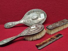 A FOUR PIECE SILVER BACKED BRUSH AND COMB SET BY DEAKIN AND FRANCIS, BIRMINGHAM 1979 DECORATED