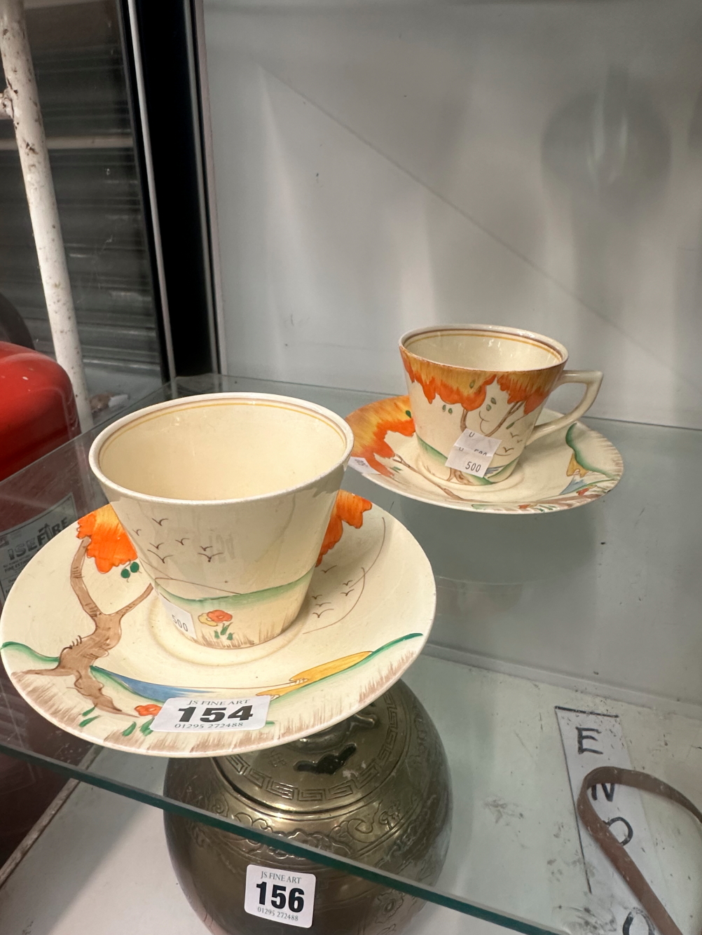A PAIR OF CLARICE CLIFF CUPS AND SAUCERS