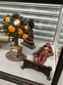 THREE CAST IRON DOOR STOPS CAST AS A NAVAL FIGURE A WELLINGTONIAN BUST AND AN ORANGE TREE