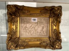 A GILT FRAMED PANEL OF BOISTEROUS PUTTI ABOUT A HORSE