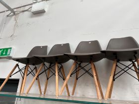 A SET OF FOUR CONTEMPORARY MOULDED PLASTIC DINING CHAIRS AFTER A DESIGN BY CHARLES EAMES (4)