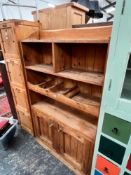 A RUSTIC PINE CABINET WITH SHELVES