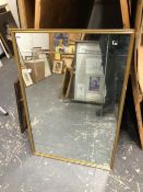 A RECTANGULAR BEVELLED MIRROR IN A GOLD FRAME