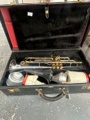 AN AMERICAN CASED TRUMPET WITH ATTACHMENTS
