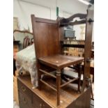 A VINTAGE OAK GENTLE MANS VALET CHAIR TOGETHER WITH A OAK ARTS AND CRAFTS STYLE SMALL BOOKCASE.(2)