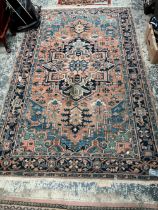 AN ANTIQUE PERSIAN HERIZ RUG. 239 x 153cms.