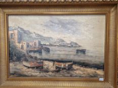 A LARGE OIL ON CANVAS OF A FISHING VILLAGE IN AN ORNATE GILT FRAME