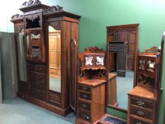 A LATE VICTORIAN WALNUT PART BEDROOM SET,  A MIRROR BACKED DRESSING TABLE AND A COMPACTUM WARDROBE