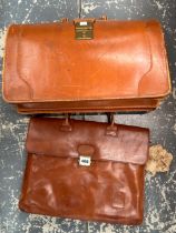 A LEATHER BRIEF CASE TOGETHER WITH ANOTHER BY SERETS