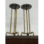 A PAIR OF BRASS ADJUSTABLE SHOP STANDS, ECH CIRCULAR TOP ON THREE COLUMNS AND FEET