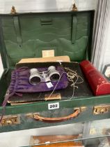 A GREEN ATTACHE CASE CONTAINING OPERA GLASSES, COINS. POSTCARDS, AN AUTOGRAPH ALBUM AND EPHEMERA