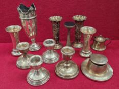 A COLLECTION OF LOADED SILVER. BUD VASES, DWARF CANDLESTICKS, INKWELL OTHER VASES ETC.