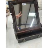 A CHINESE HARDWOOD FRAMED FOLDING MIRROR WITH A DRAWER BELOW.