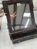 A CHINESE HARDWOOD FRAMED FOLDING MIRROR WITH A DRAWER BELOW.