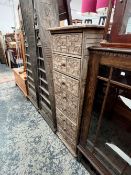 AN AFRICAN CARVED TRIBAL EIGHT DRAWER TALL CHEST