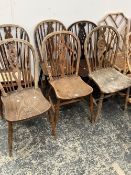 A MATCHED SET OF SIX WINDSOR WHEEL BACK CHAIRS, INCLUDES ONE ARMCHAIR.