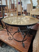 A EASTERN BRASS TRAY TOP LOW TABLE, WROUGHT IRON FRAME, TOGETHER WITH ANOTHER WROUGHT IRON STAND (