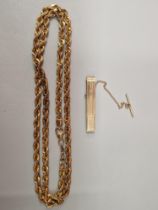 A 14ct STAMP TIE SLIDE WITH SAFETY CHAIN AND T-BAR, TOGETHER WITH A SILVER AND 9ct GOLD BONDED