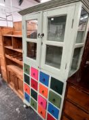 AN EASTERN PAINTED GLAZED CABINET WITH MULTI DRAWER LOWER SECTION