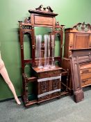 A CARVED LATE VICTORIAN STYLE HALL STAND WITH APRON DRAWER AND CUPBOARD SECTION.