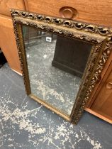 A GILT FRAMED MIRROR