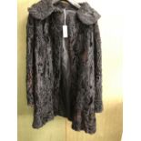 JACKET. LADYS HALF LENGTH COAT OR JACKET: BLACK ASTRAKHAN, ARMPIT TO ARMPIT 51, NECK TO HEM 93cms.