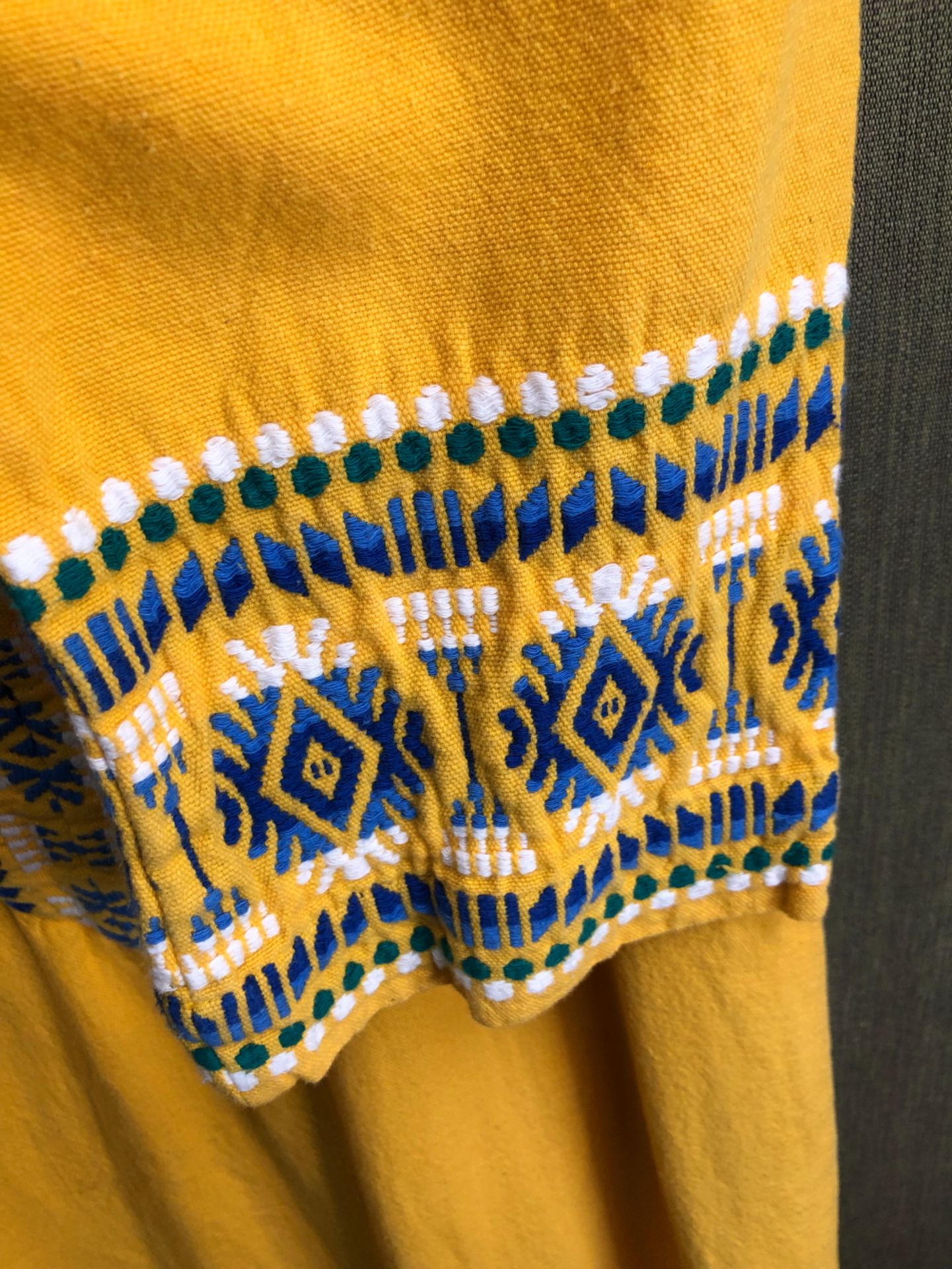 KAFTAN: A YELLOW GROUND KAFTAN DRESS TRIMMED WITH BLUE, GREEN AND WHITE GEOMETRIC BANDS, SLEEVE - Image 3 of 5