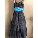 A BLACK EVENING DRESS WITH BRIGHT BLUE RIBBON