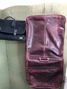 A BURGUNDY HEAVY LEATHER SUIT CARRIER WITH A BLACK SUEDETTE TRAVEL BAG (2)
