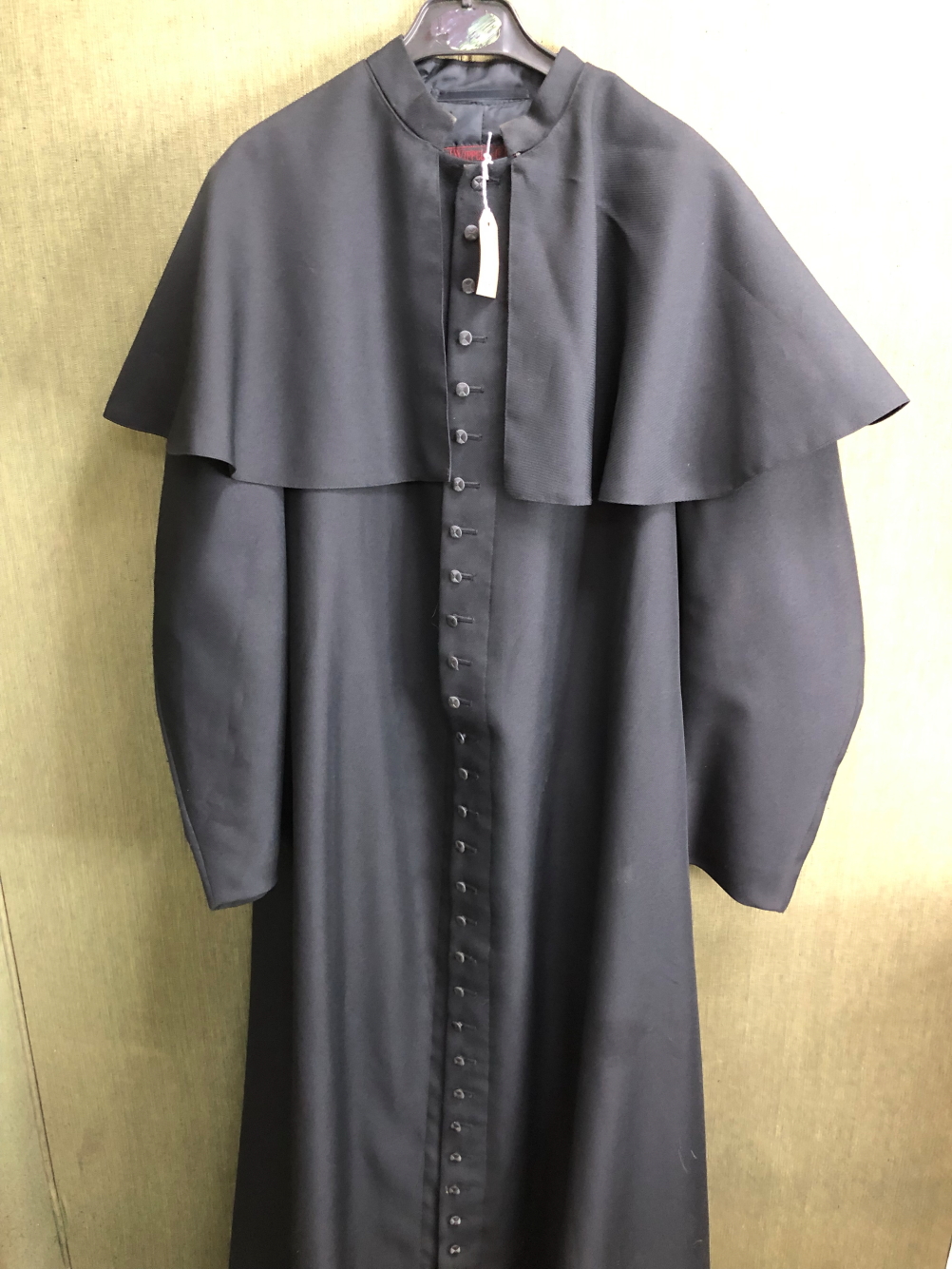 CASSOCK. A WIPPELL & CO ROMAN CATHOLIC BLACK CAPED CASSOCK. SHOULDER TO HEM 154cms.