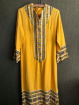 KAFTAN: A YELLOW GROUND KAFTAN DRESS TRIMMED WITH BLUE, GREEN AND WHITE GEOMETRIC BANDS, SLEEVE