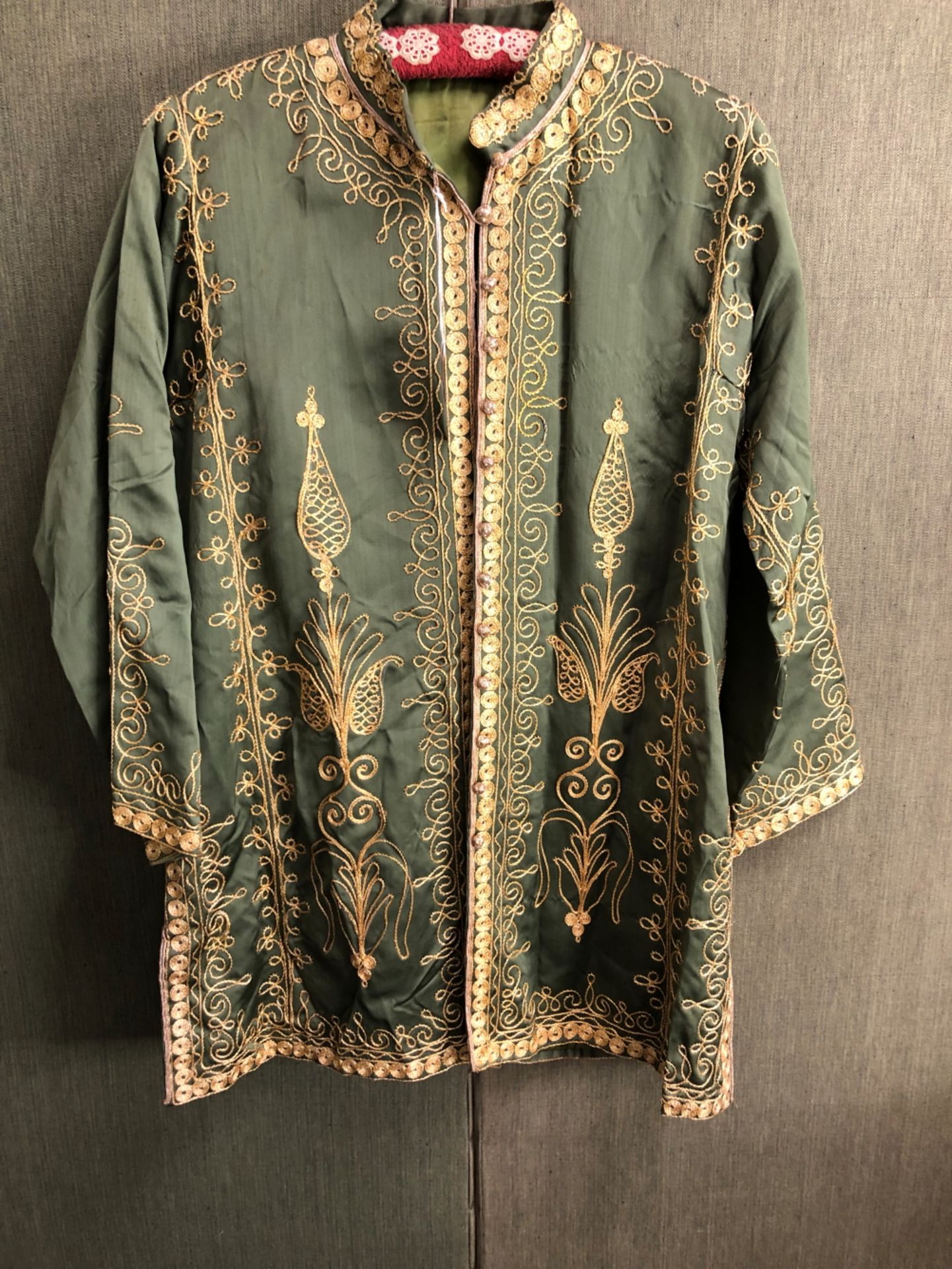 JACKET, AN INDIAN GREEN SILK JACKET EMBROIDERED IN GOLD THREAD, SLEEVE LENGTH 48cms, NECK TO HEM