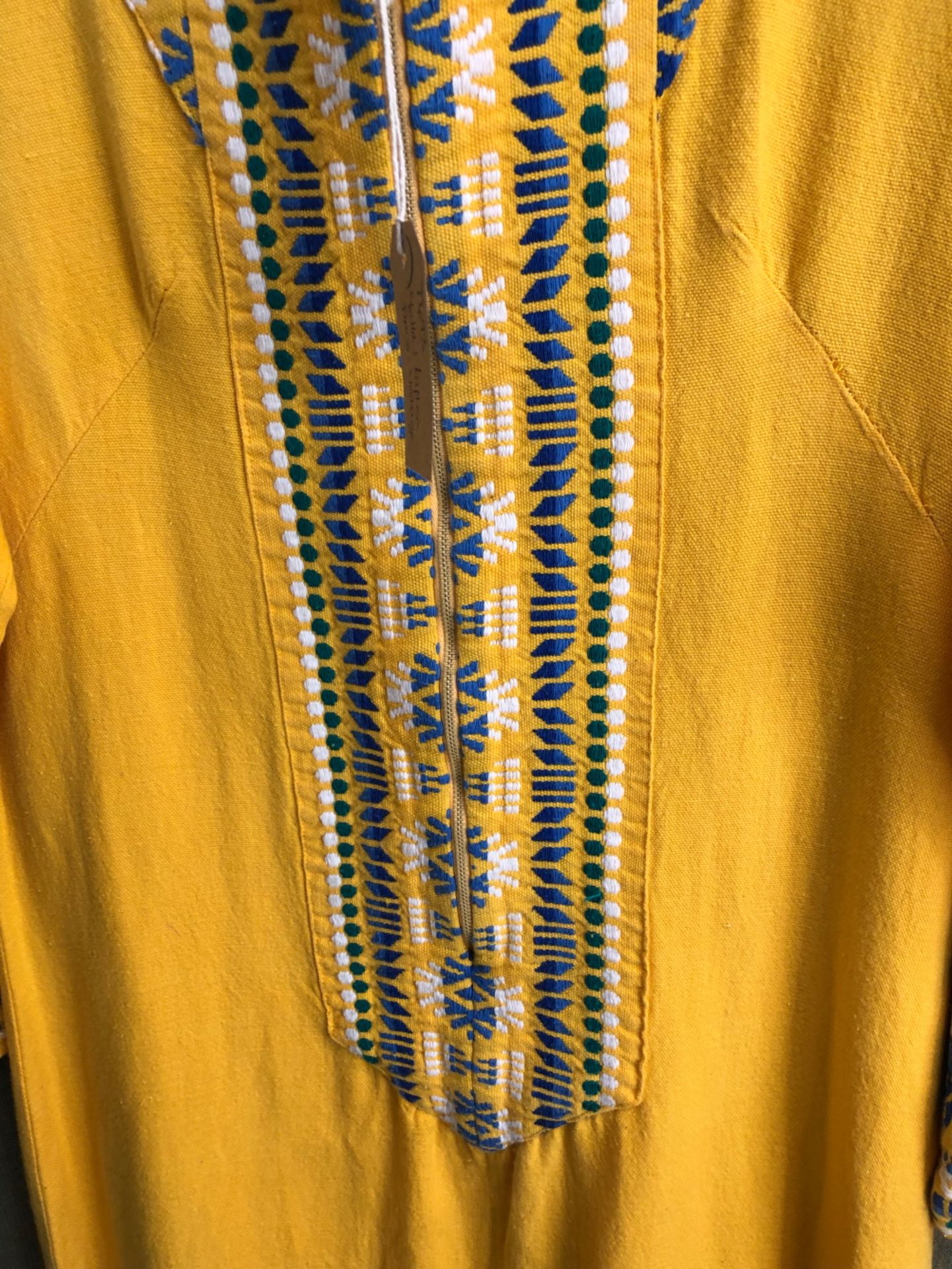 KAFTAN: A YELLOW GROUND KAFTAN DRESS TRIMMED WITH BLUE, GREEN AND WHITE GEOMETRIC BANDS, SLEEVE - Image 2 of 5
