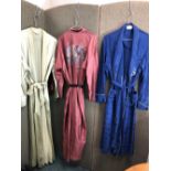 THREE SILK DRESSING GOWNS, TO INCLUDE A NAVY HEALTH EXAMPLE WITH BLUE PATTERN,A GREEN MOALIJIA